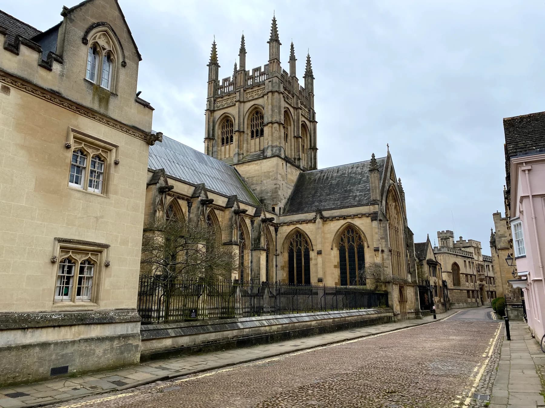 An empty cobbled Oxford street beside a stone church