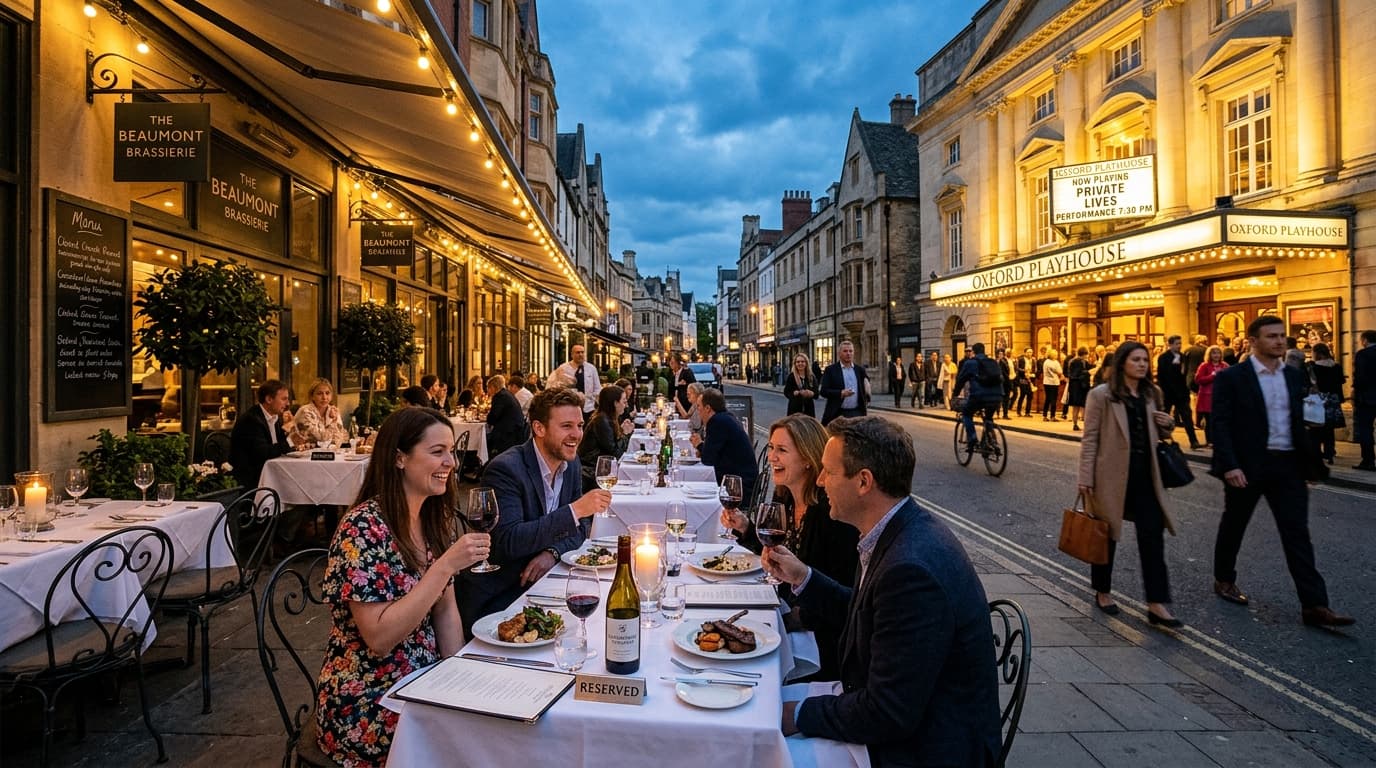 Diners enjoying an early evening pre-theatre terrace dinner opposite the illuminated Oxford Playhouse
